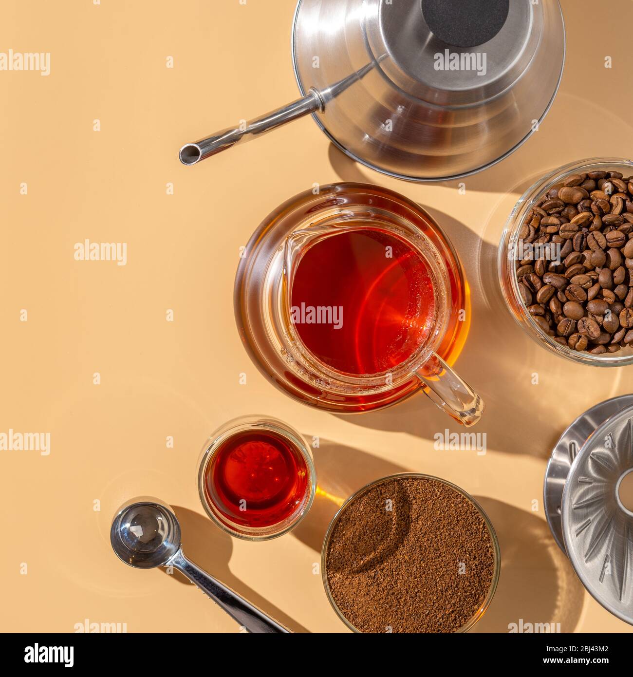 https://c8.alamy.com/comp/2BJ43M2/glass-teapot-with-freshly-brewed-coffee-alternative-method-pour-over-coffeehard-light-beige-background-2BJ43M2.jpg