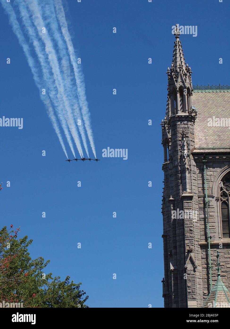 US Navy Blue Angels and US Air Force Thunderbirds over Newark, New Jersey USA on April 28th, 2020 in a tribute to the first responders and essential workers who have been on the front lines of the Covid-19 pandemic. Under a crystal clear blue sky the planes are seen over Newark, New Jersey's Sacred Heart Cathedral as they head north. Twelve aircraft in total passed seconds apart over the city. Photo credit: Tom Cassidy/ Alamy Stock Photo