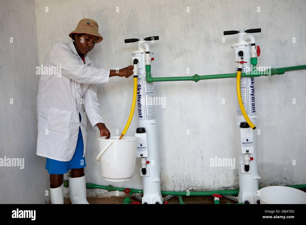 Miriam works on the water place in Mungetho, north of Naurobi and examines the water filter plant. Stock Photo