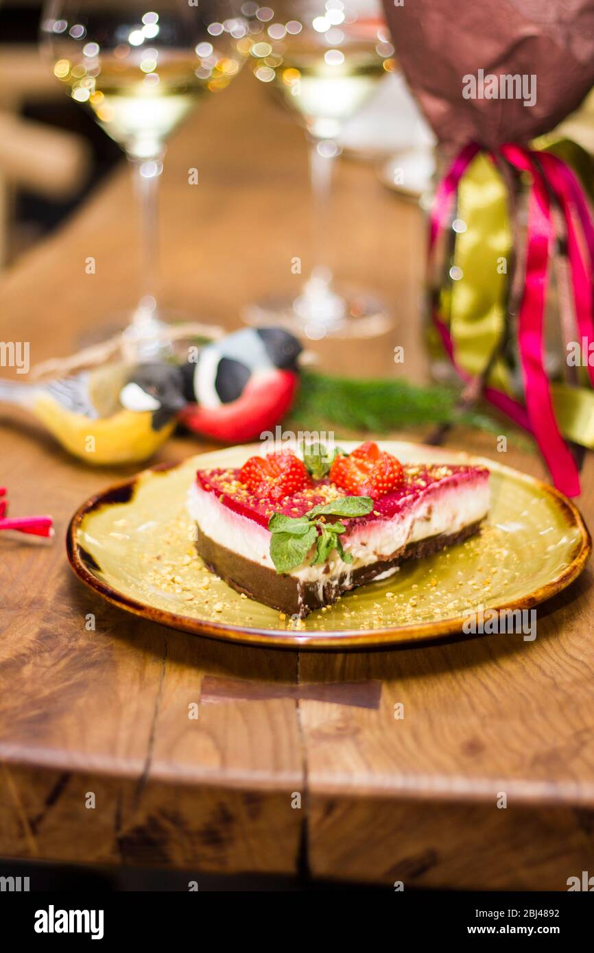 A pie with fresh strawberries is decorated with mint leaves Stock Photo