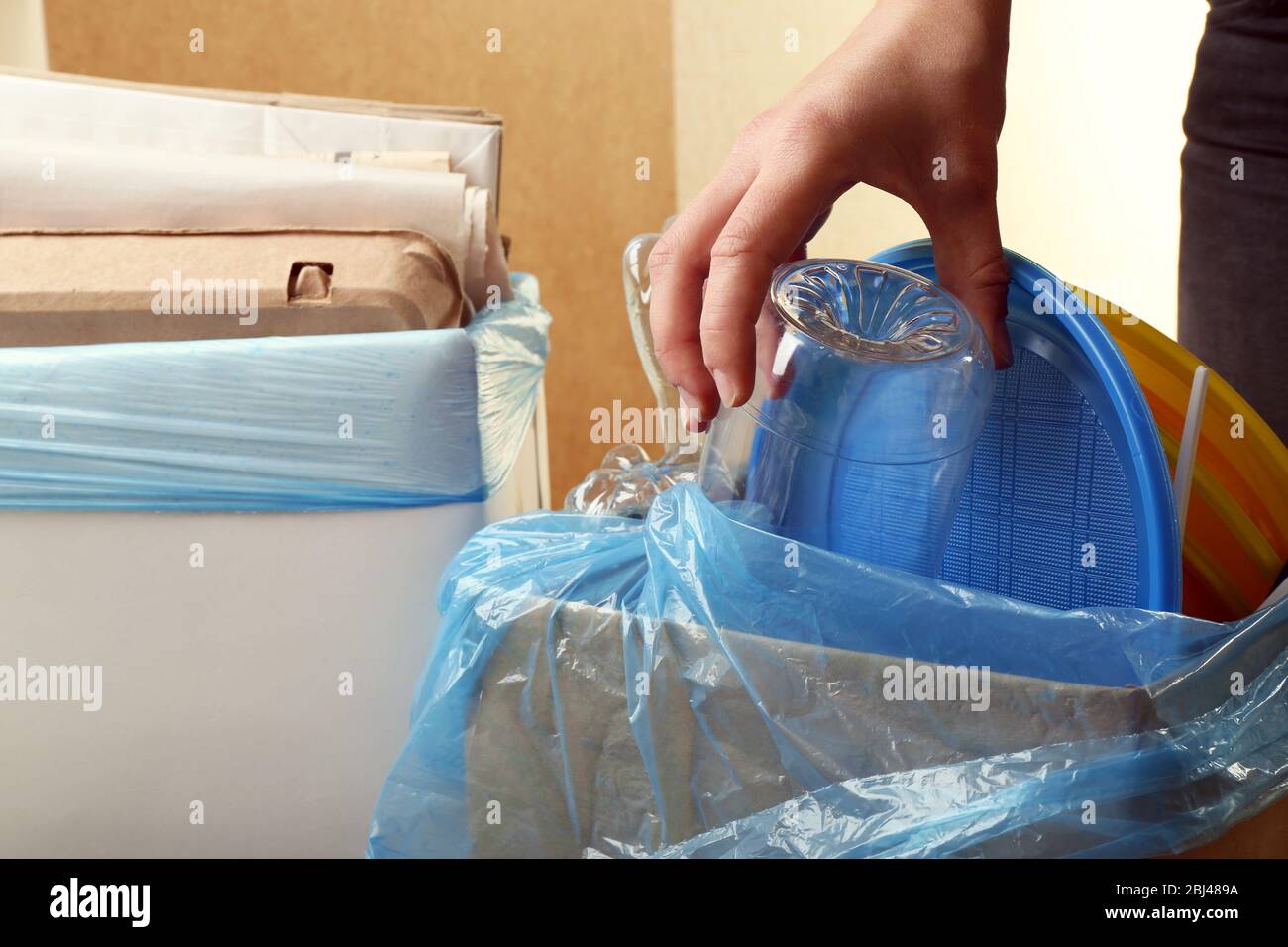 Woman sorting different waste, indoors Stock Photo