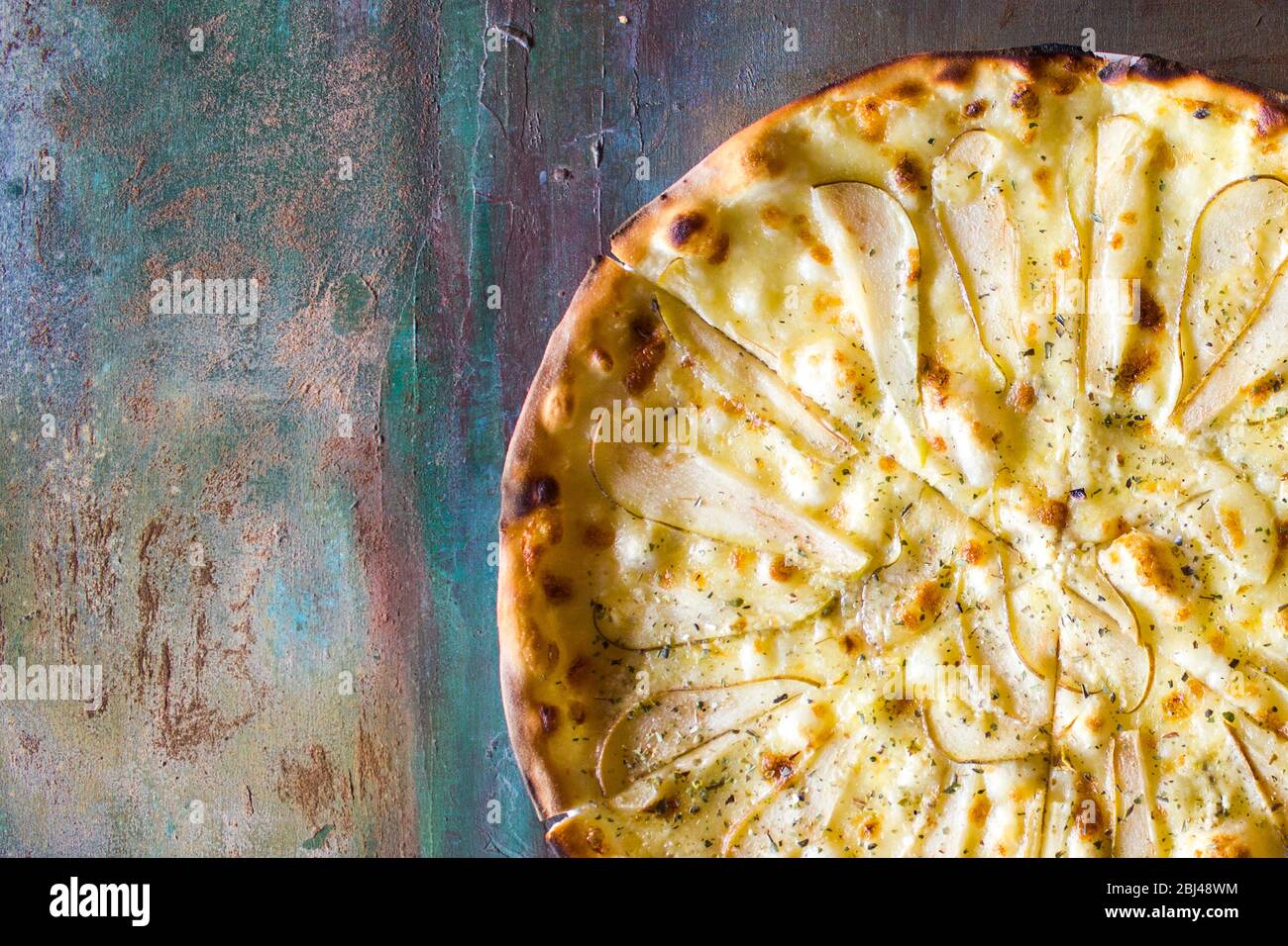 Pizza from slices of pear. Baking in a plate on the table Stock Photo