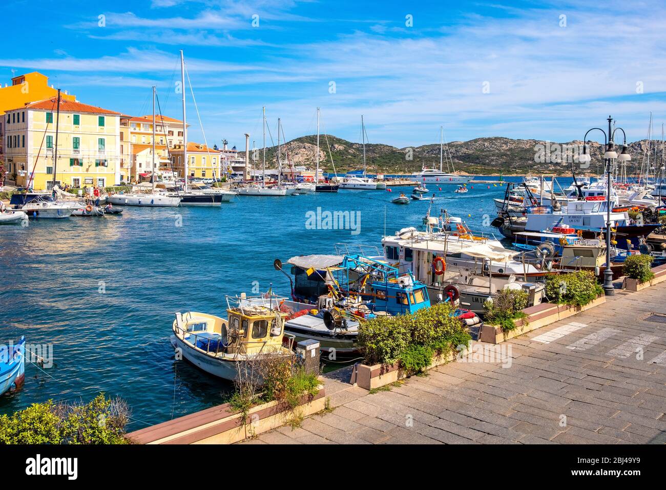 La Maddalena, Sardinia / Italy - 2019/07/17: Panoramic view of La Maddalena port - Porto di Cala Gavetta - and marina quarter at the Tyrrhenian Sea Stock Photo
