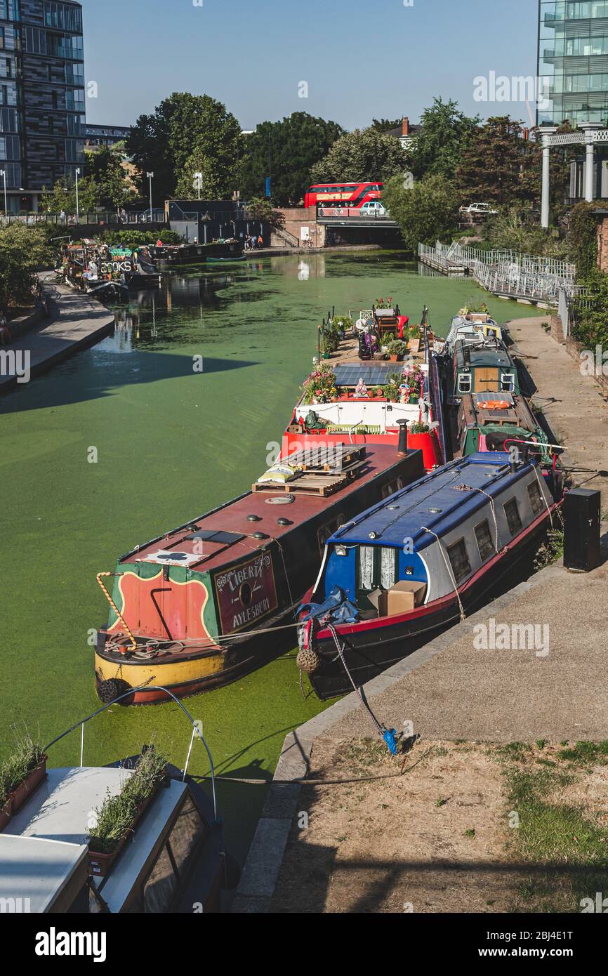 London/UK-26/07/18: narrowboats moored along the Regents Canal near Kings Cross Central. A narrowboat is a boat of a particular design, made to fit th Stock Photo