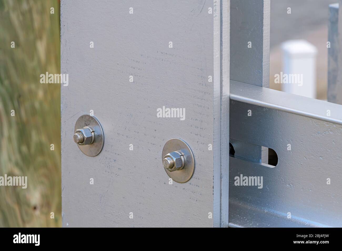 two stainless steel bolts, washers, lock washers, and nuts joining