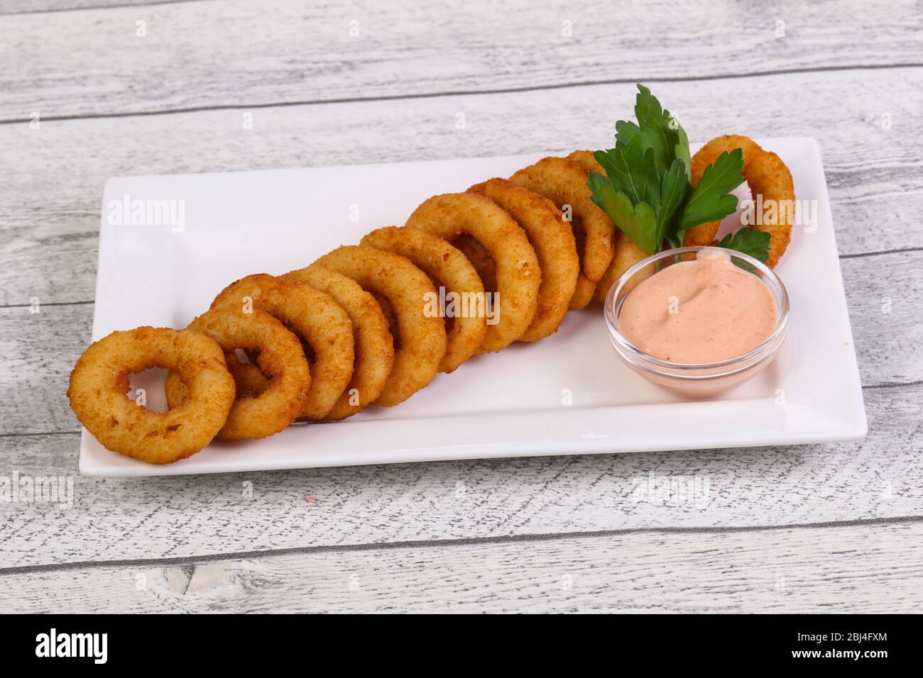 Hot onion rings snack with sauce served parsley Stock Photo Alamy