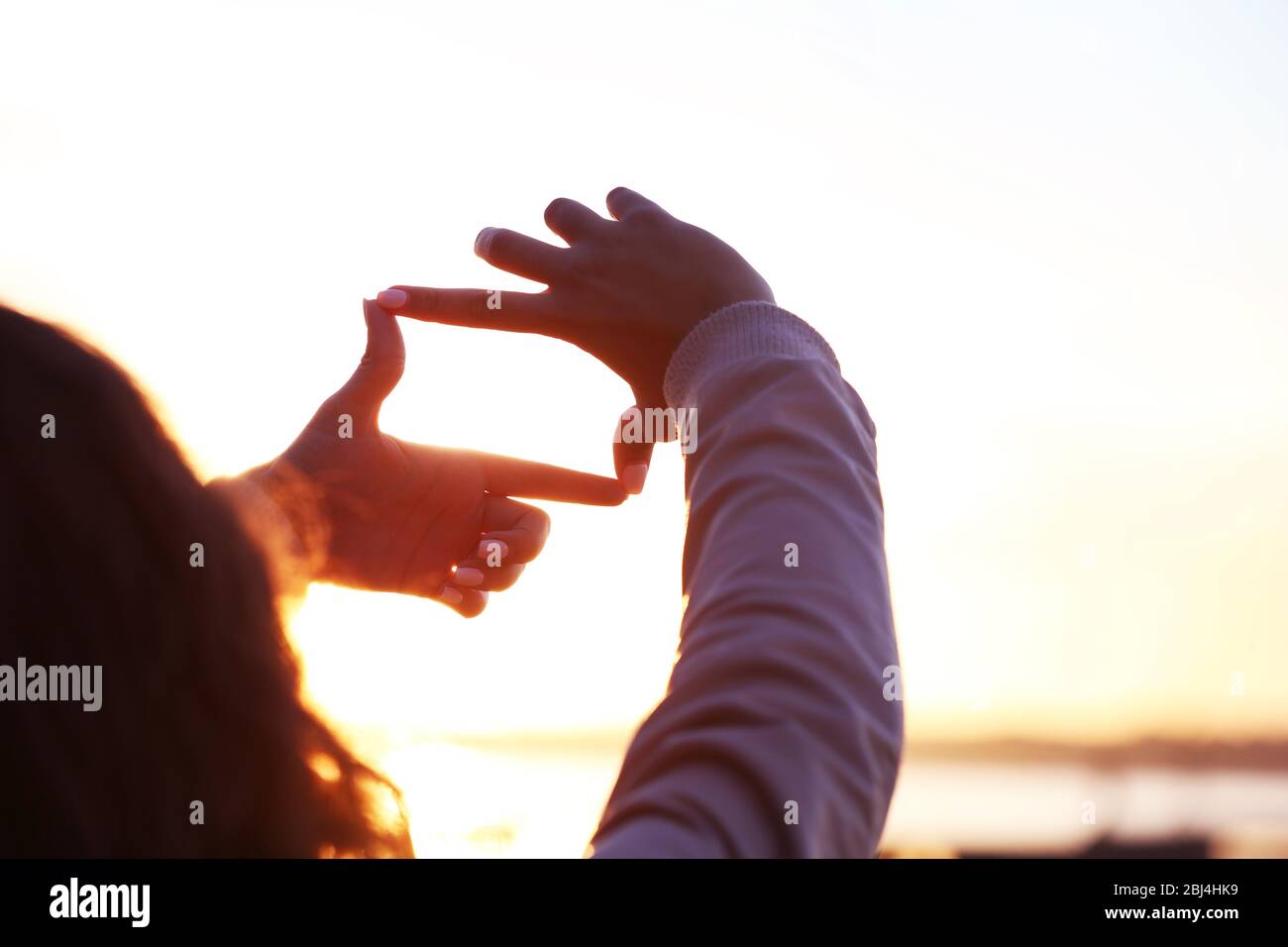 Hands on sunlight background Stock Photo - Alamy
