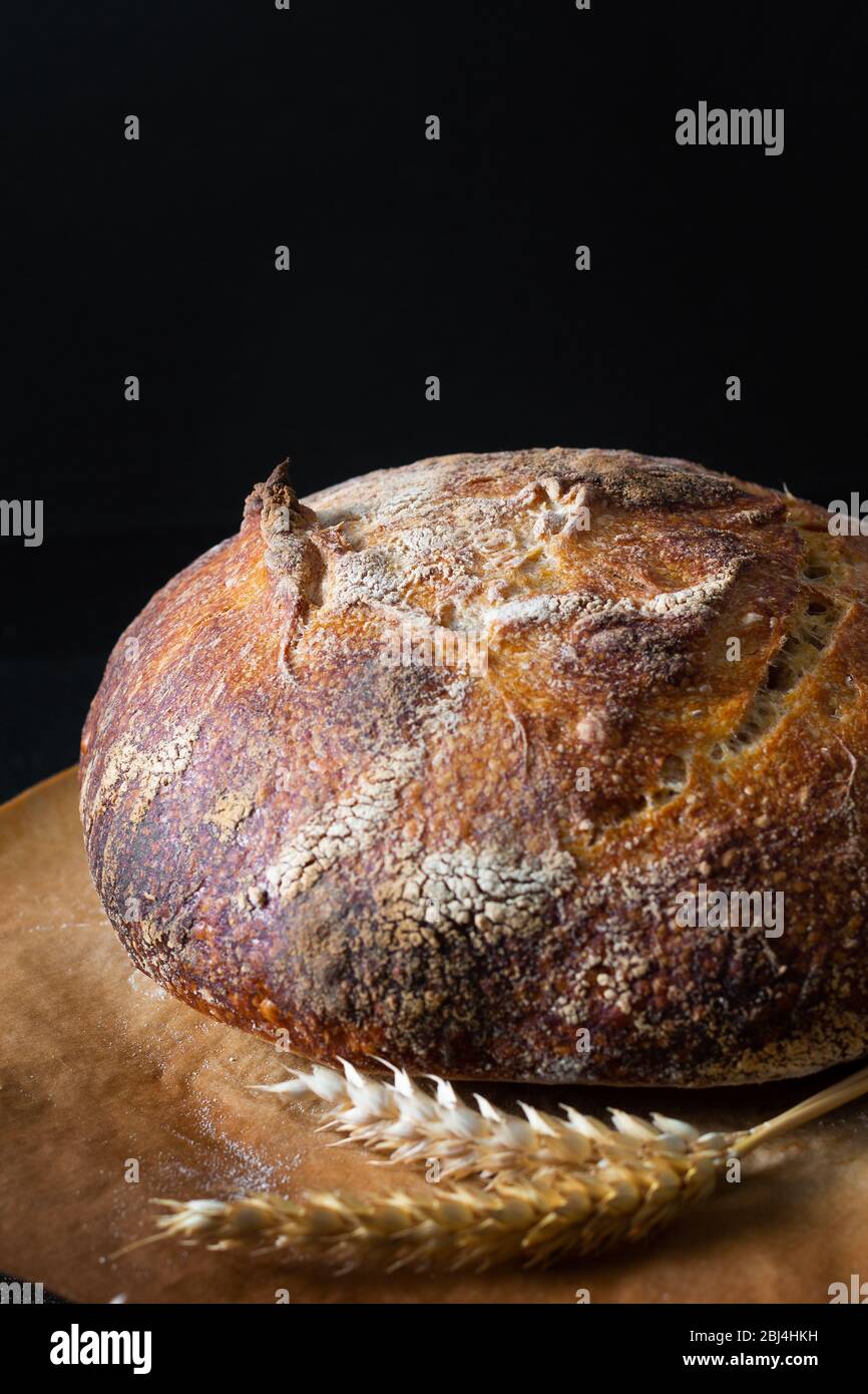 Home Cooking Homemade Organic Sourdough bread on black background with copy space Stock Photo