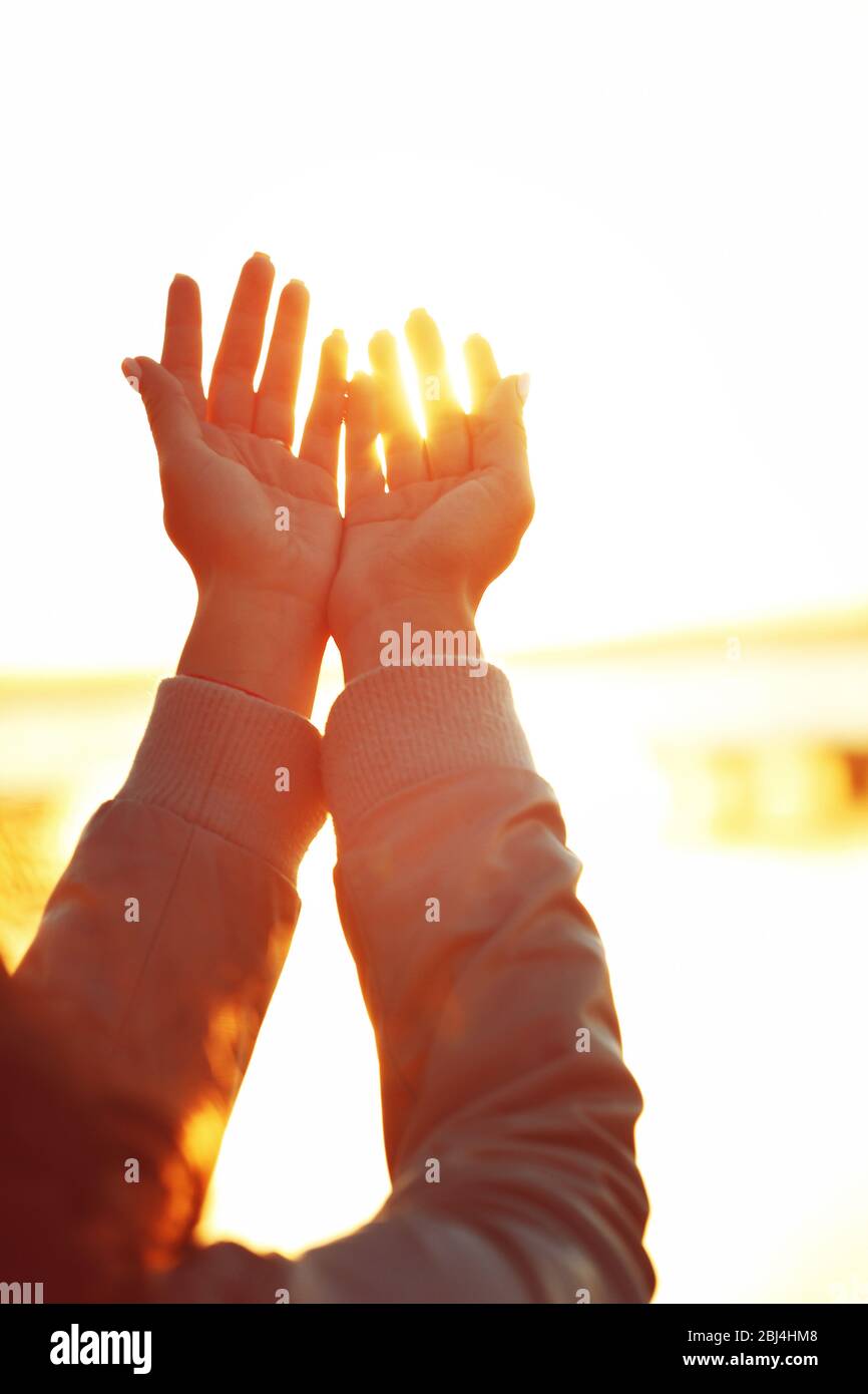 Hands on sunlight background Stock Photo - Alamy