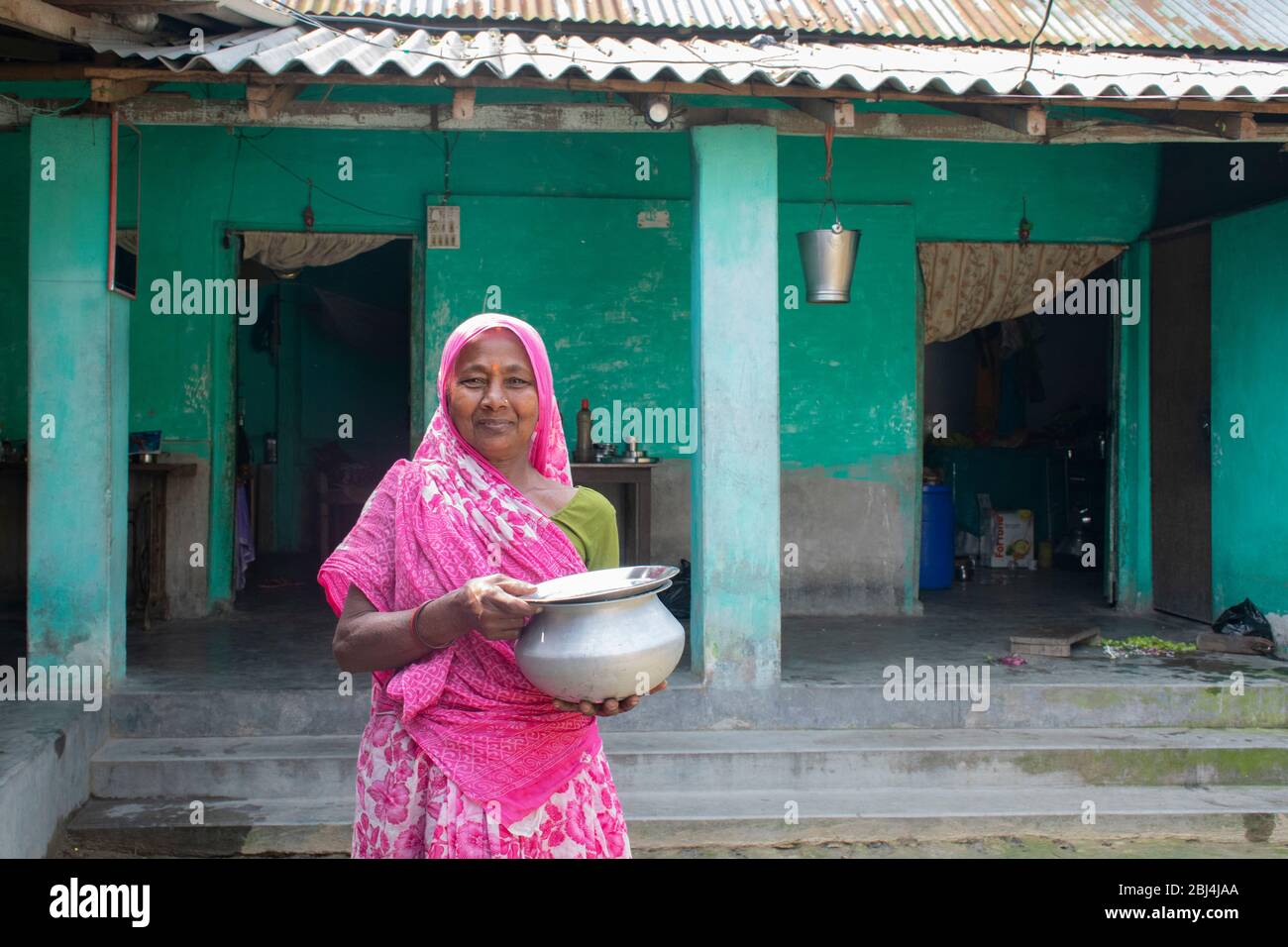 Indian woman in sari at her house in village Stock Photo