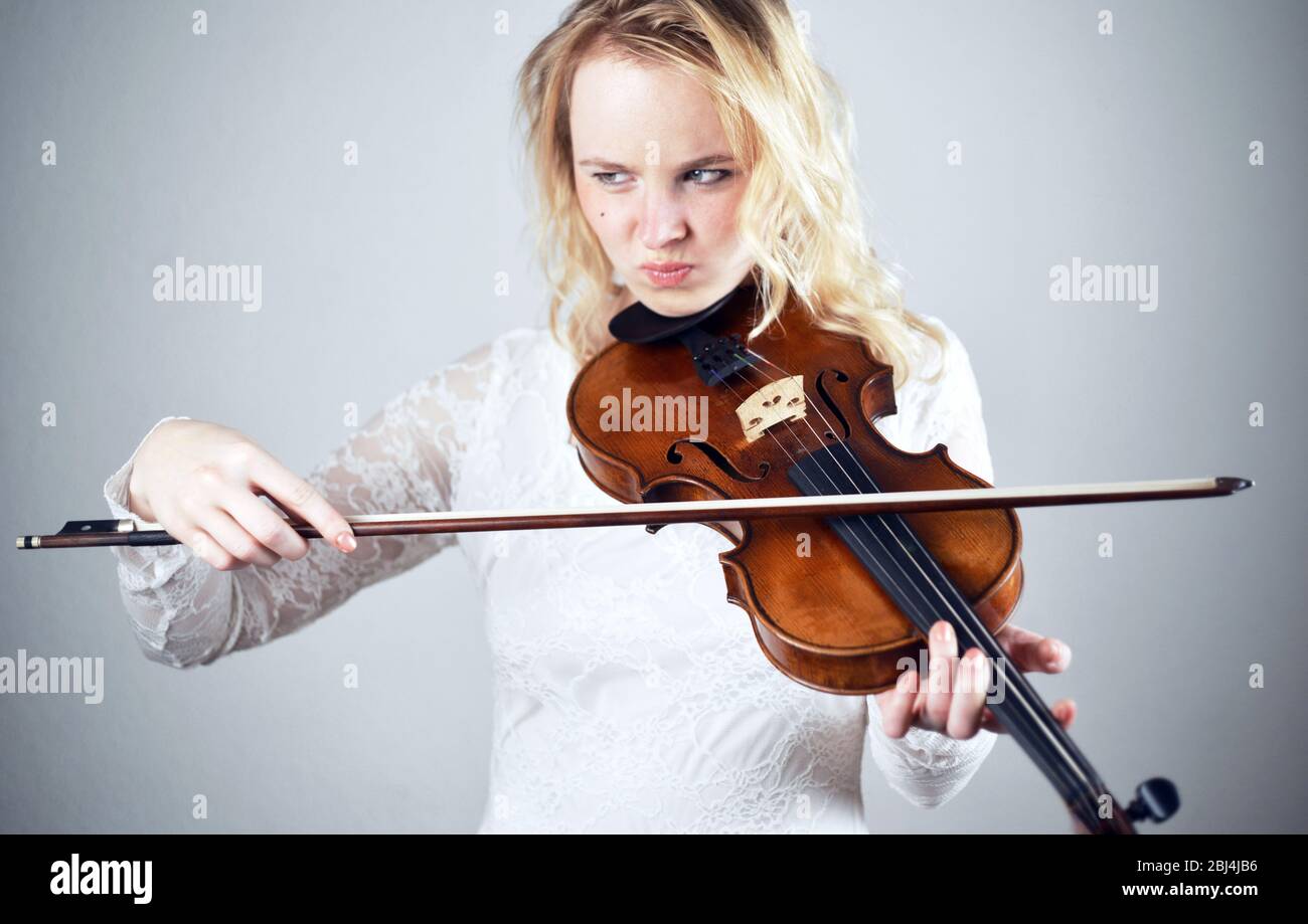 female pretends to play violin Stock Photo Alamy