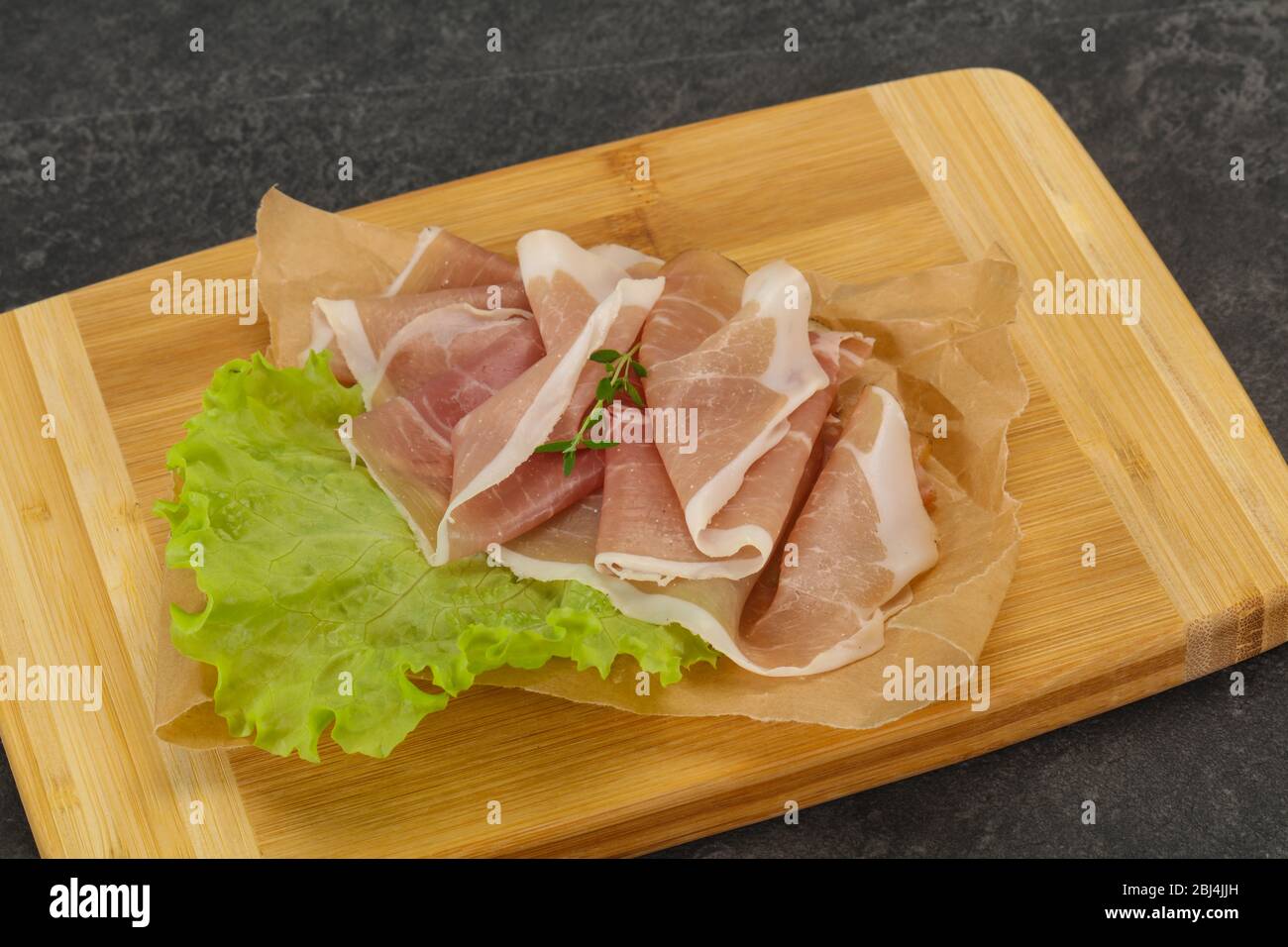 Italian prosciutto pork meat snack over board Stock Photo Alamy