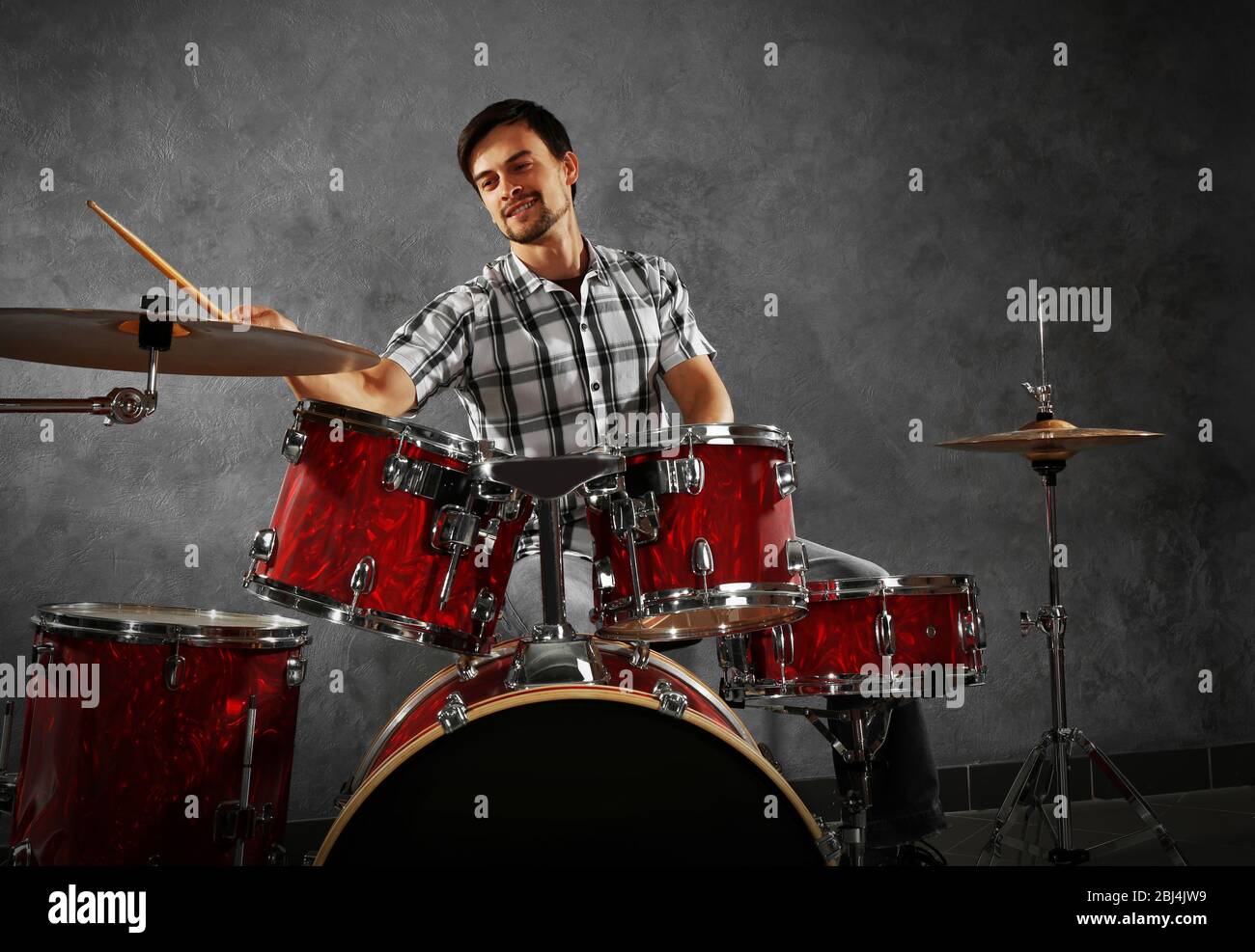Musician playing the drums in a studio Stock Photo - Alamy