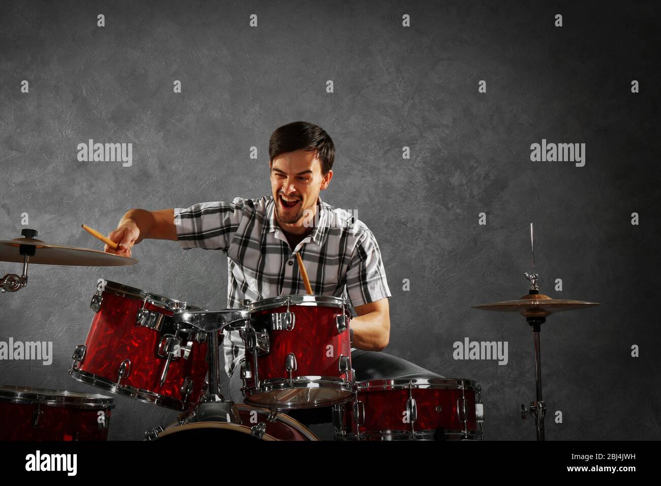 Musician playing the drums in a studio Stock Photo - Alamy