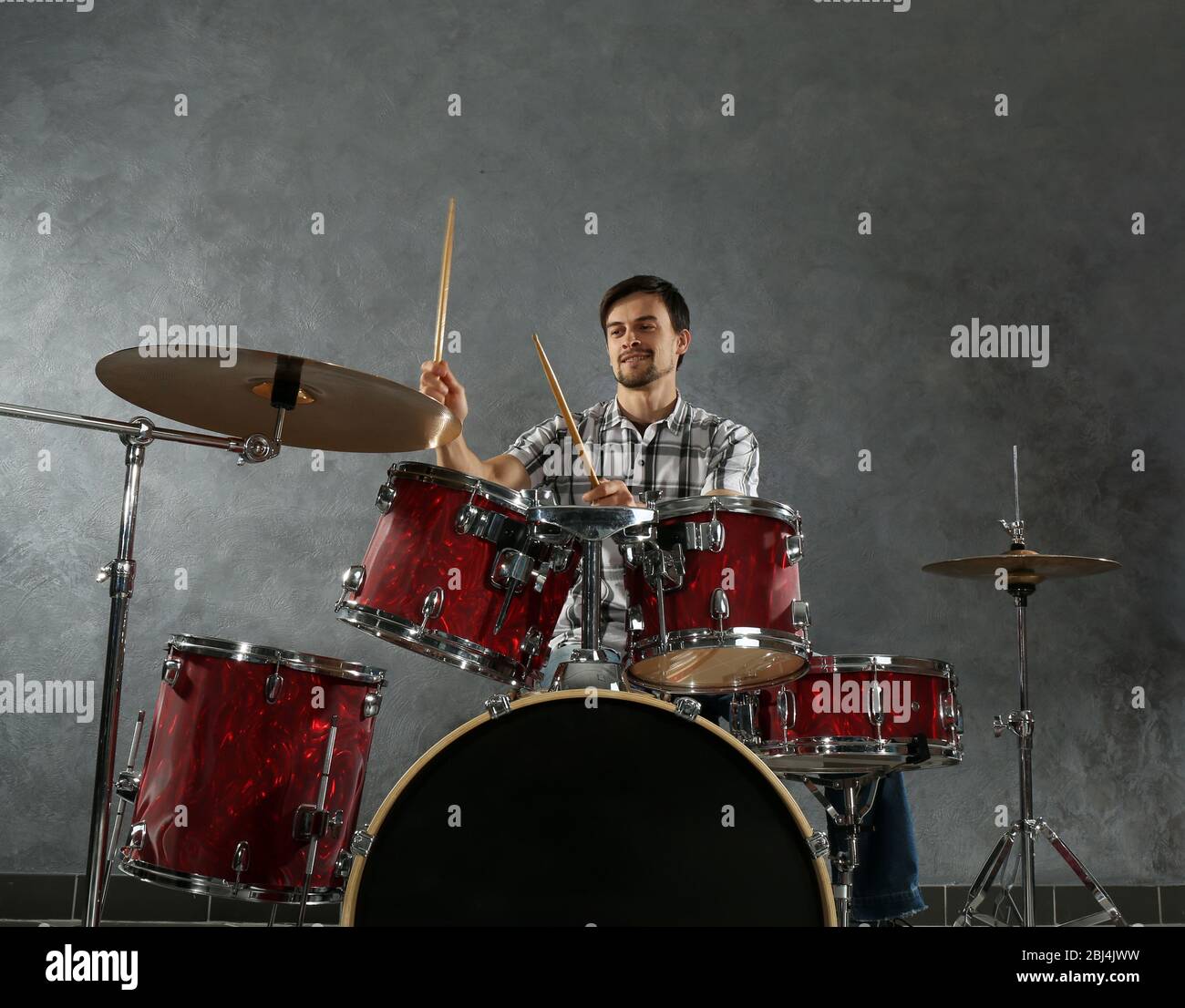 Musician playing the drums in a studio Stock Photo - Alamy