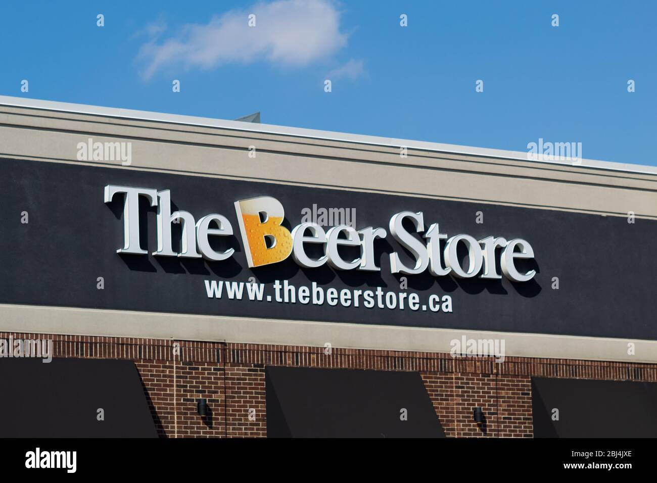 The Beer Store sign atop of a location, on a sunny day. Stock Photo