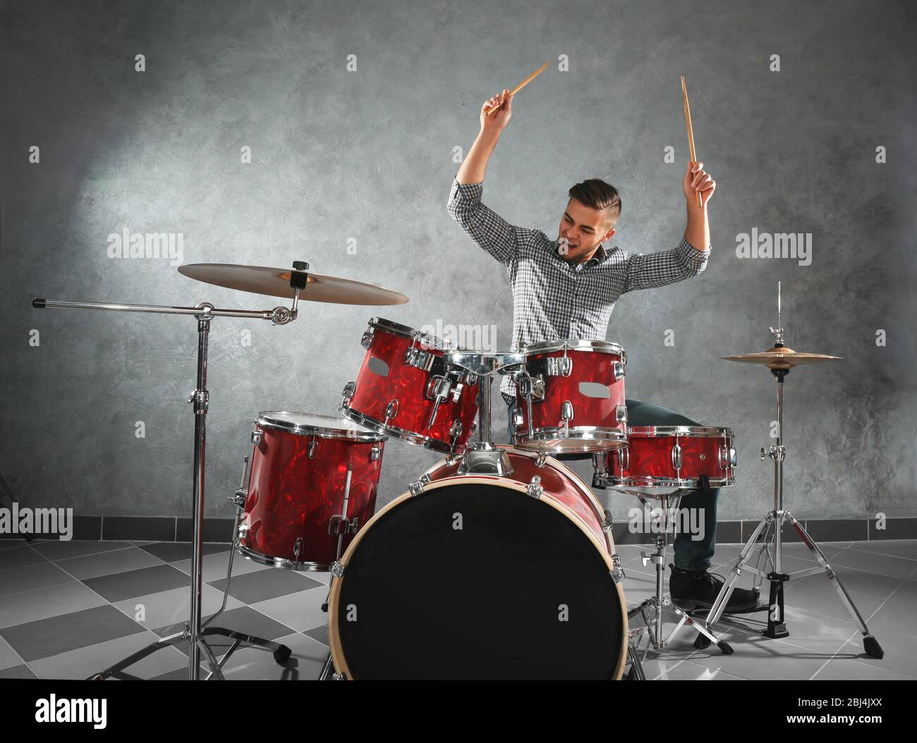Musician playing the drums in a studio Stock Photo - Alamy
