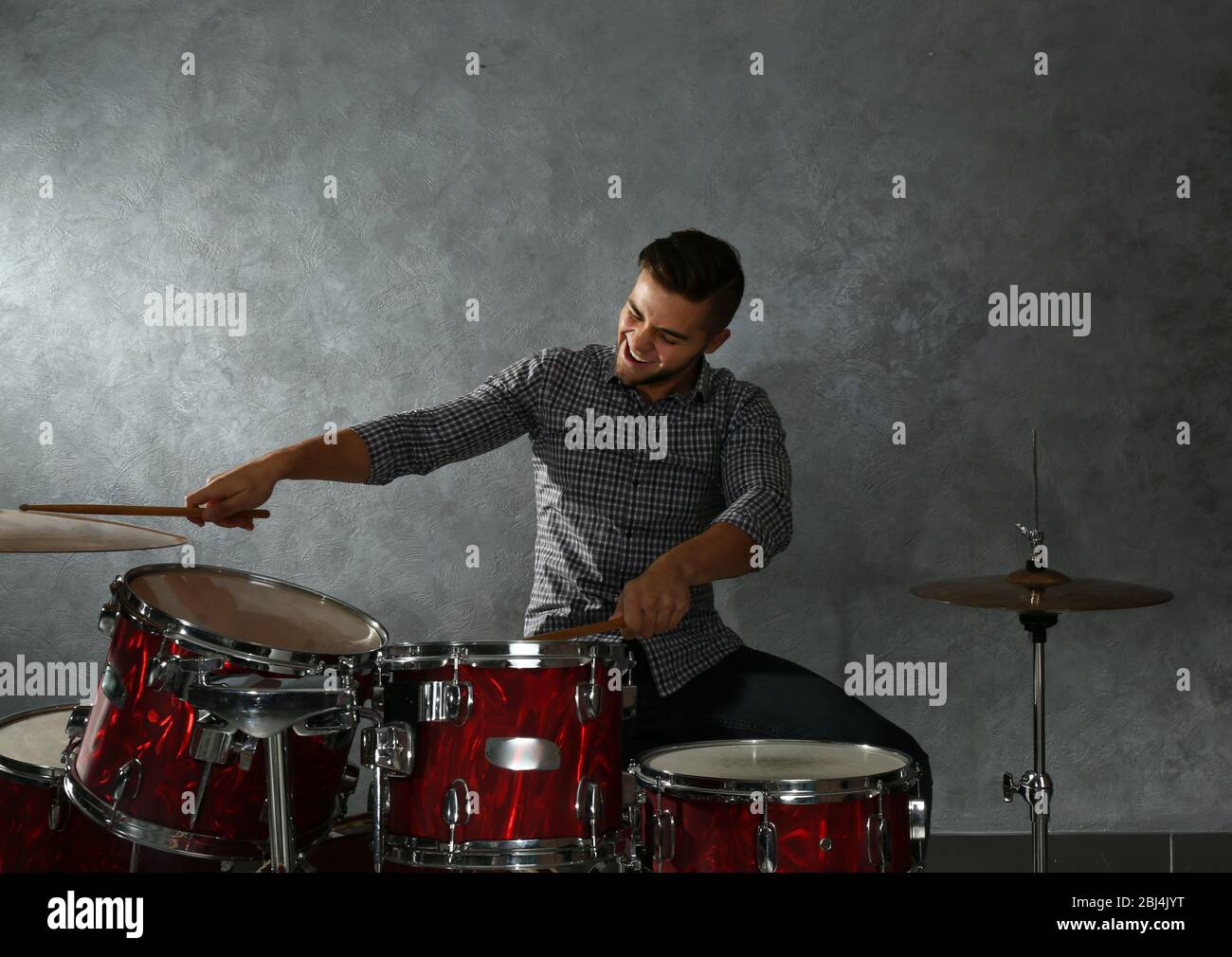 Musician playing the drums in a studio Stock Photo - Alamy