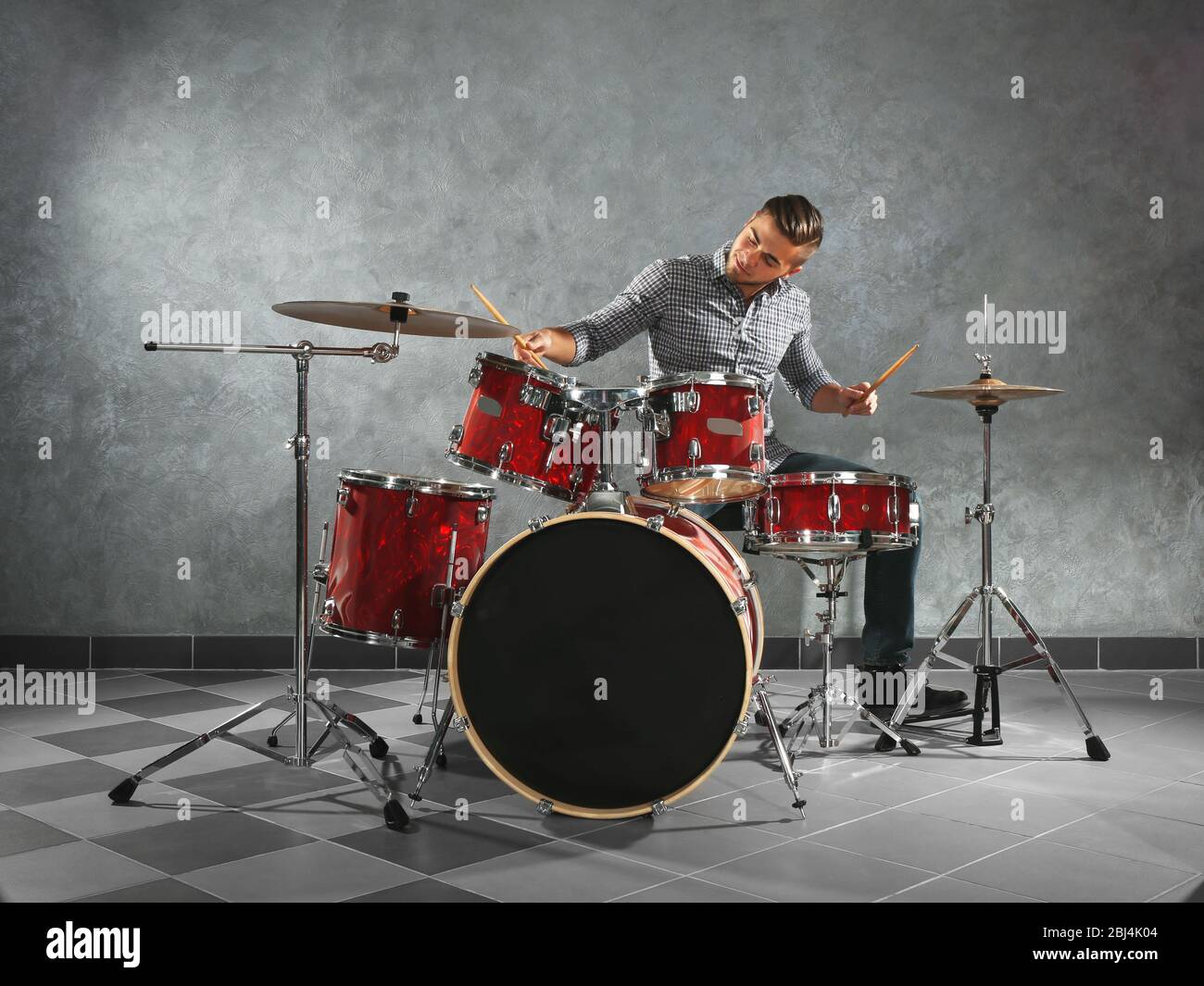 Musician playing the drums in a studio Stock Photo - Alamy