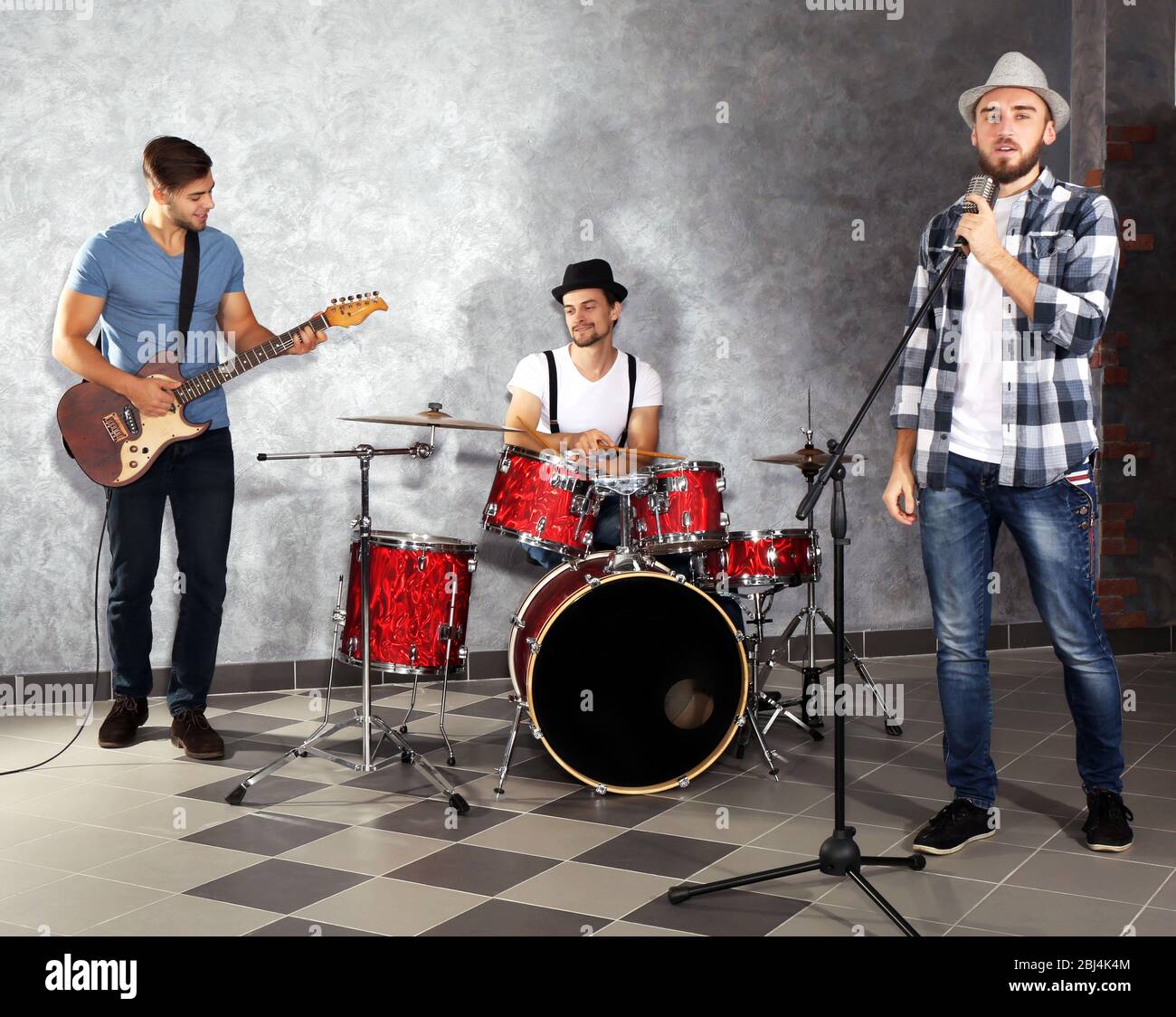 Musicians playing musical instruments and singing songs in a studio ...