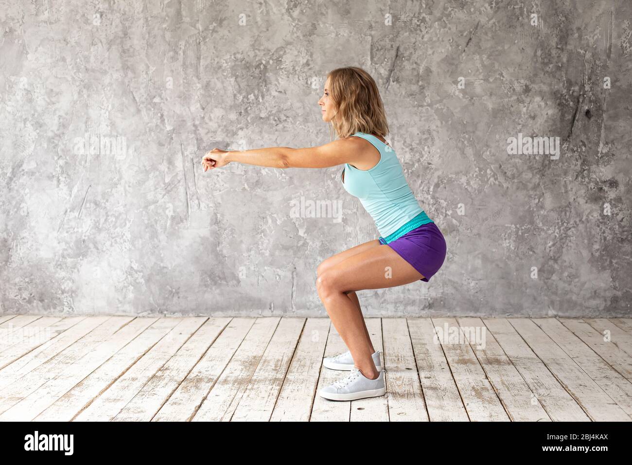 Woman squatting shorts hi-res stock photography and images - Alamy
