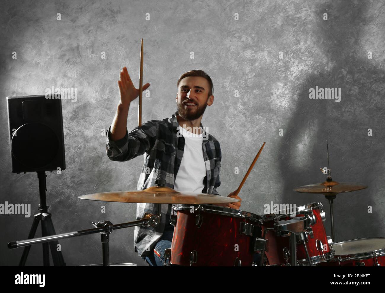 Musician playing the drums in a studio Stock Photo - Alamy