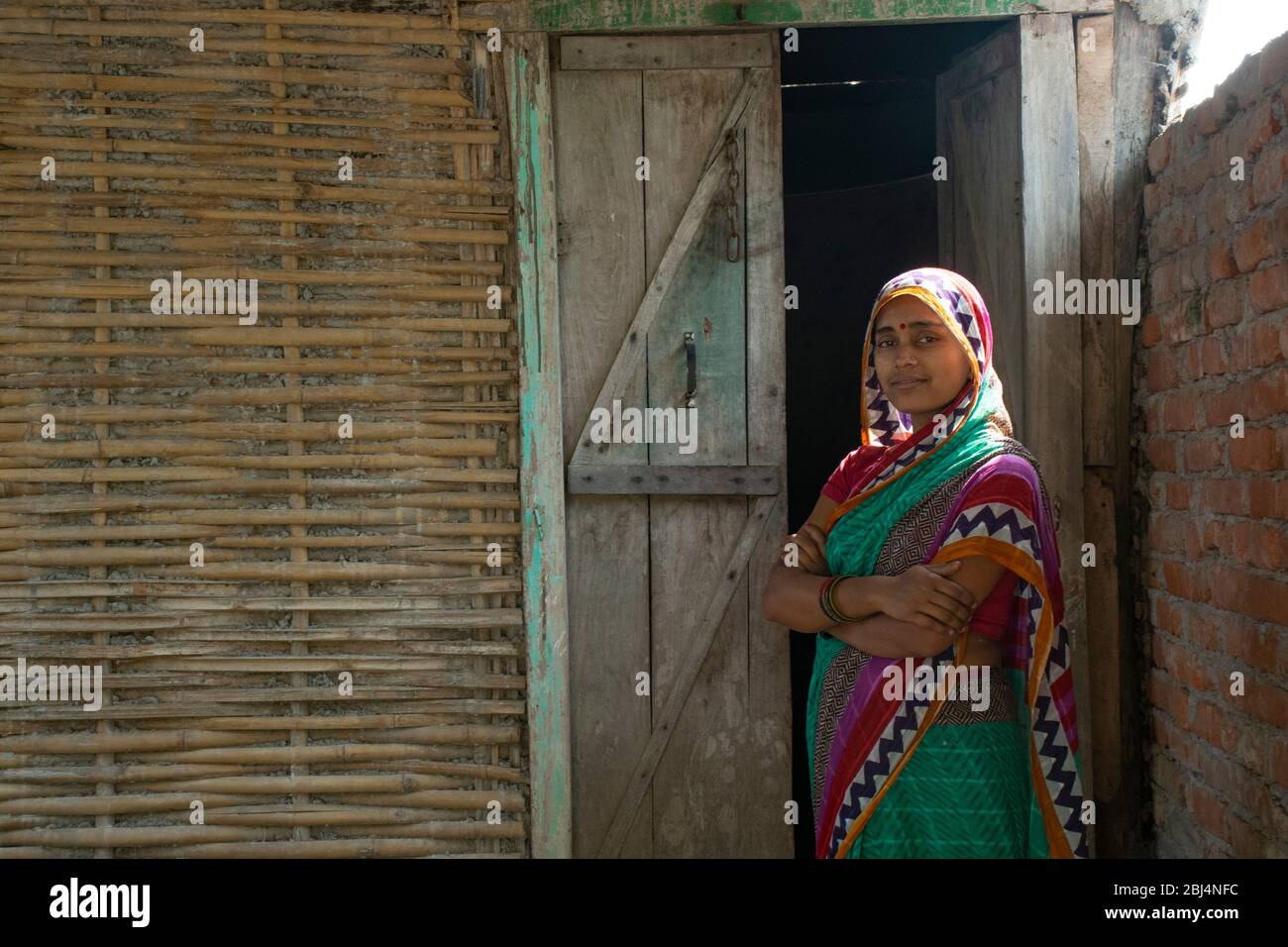 Indian woman in sari at her house in village Stock Photo