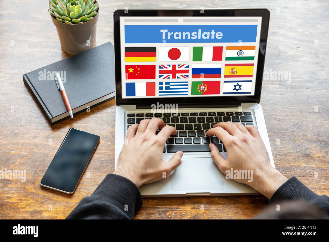 Online translation, foreign languages learning concept. Man working with a computer laptop, translate text on the screen. Stock Photo