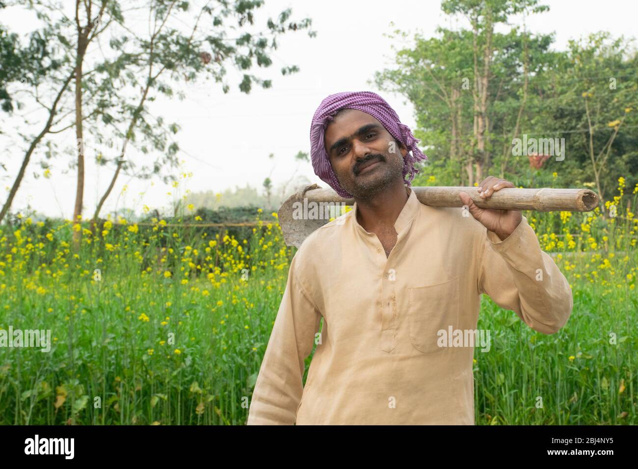 portrait of indian farmer holding hoe on shoulder Stock Photo - Alamy