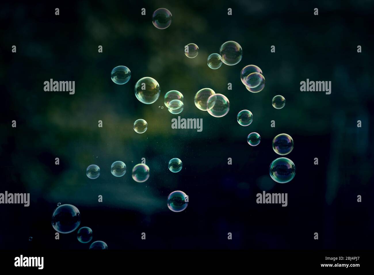 Soap bubbles on dark green background Stock Photo