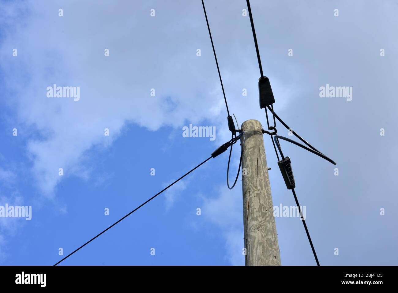 electric power lines and wooden pole Stock Photo