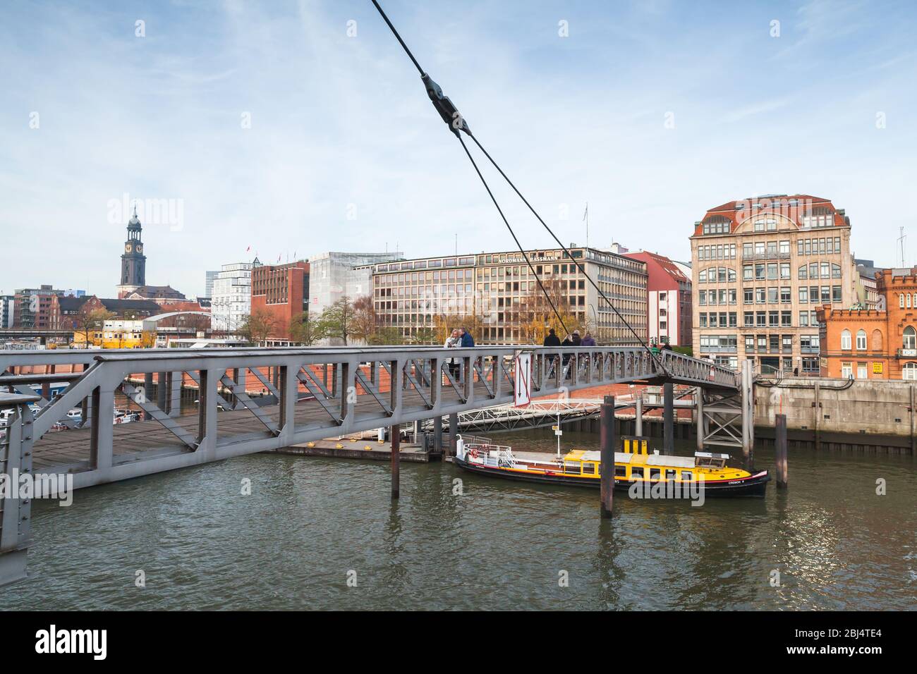 Hamburg, Germany - November 30, 2018: People walk on small pedestrian bridge over Binnenhafen, inner port of Hamburg, street view Stock Photo