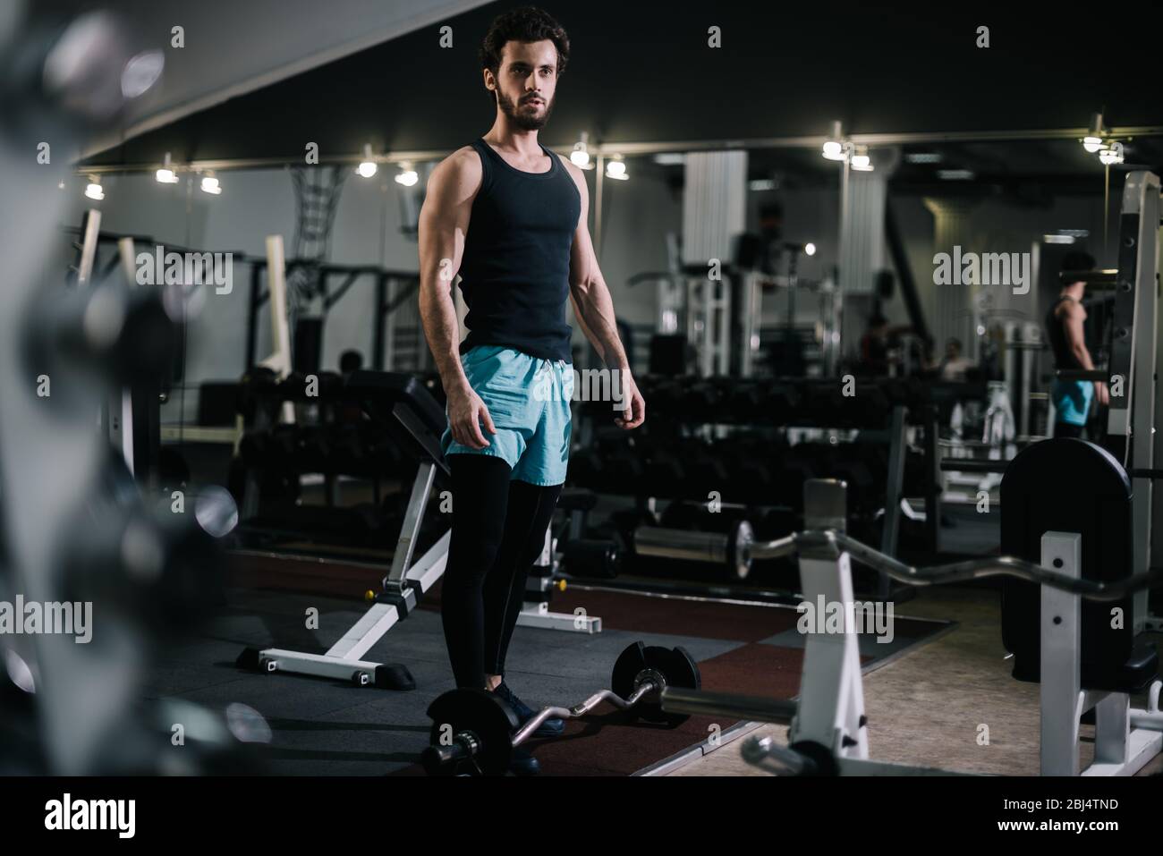 Athletic bearded young man with muscular wiry body wearing sportswear