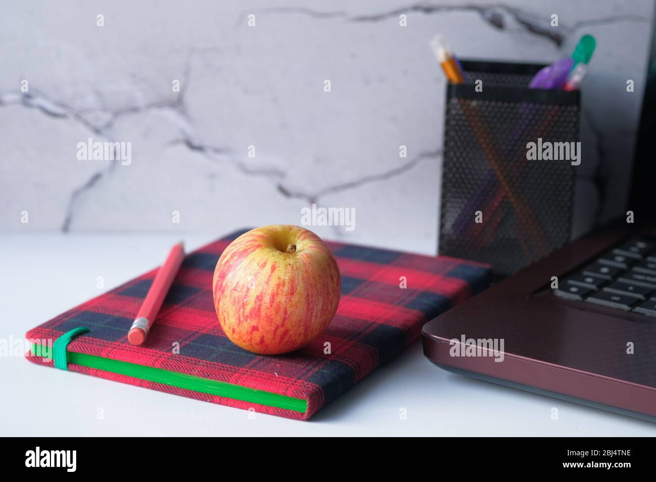 notebook with pencil and apple on table  Stock Photo