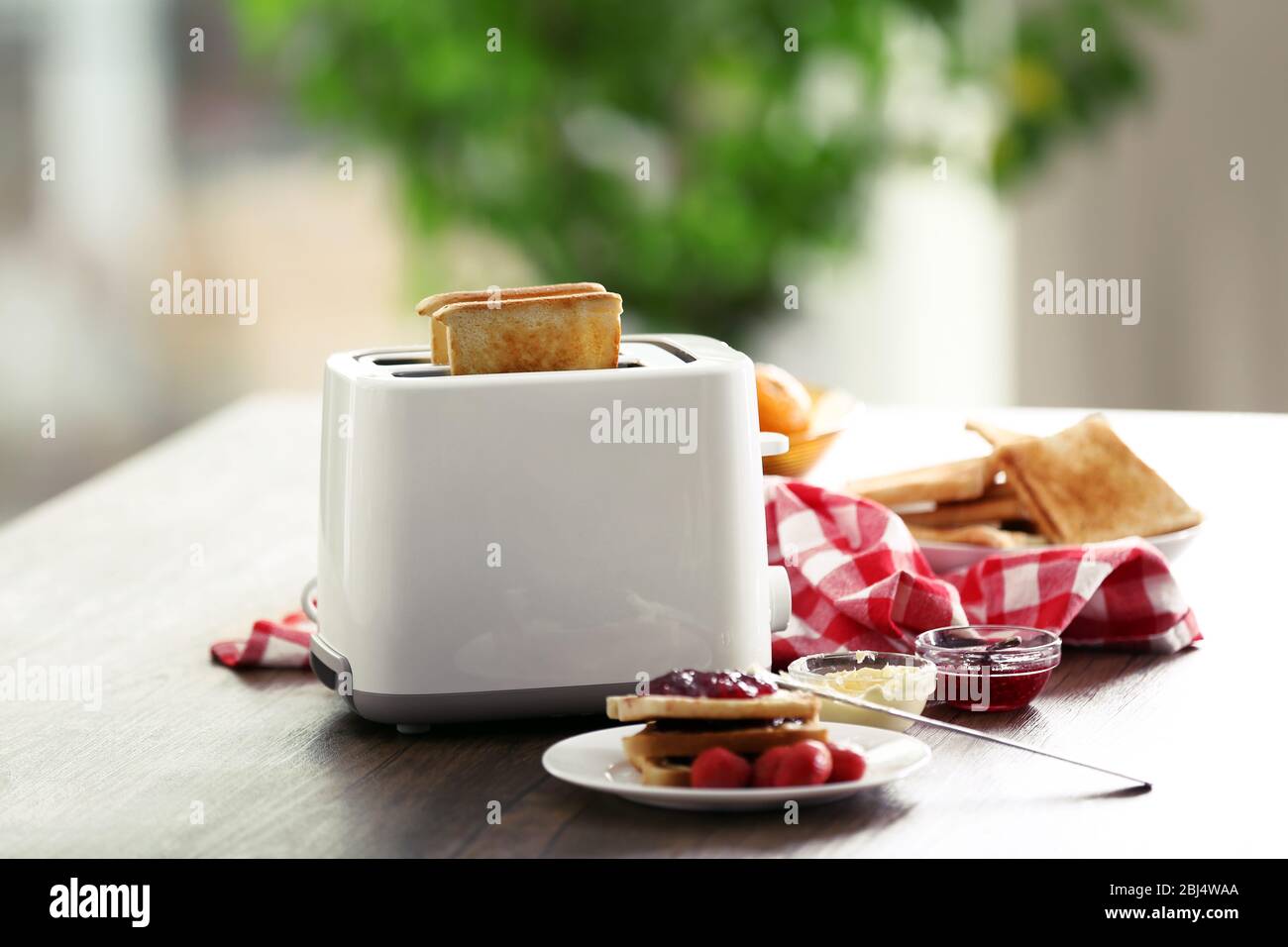 Served table for breakfast with toast and jam, on blurred background Stock Photo