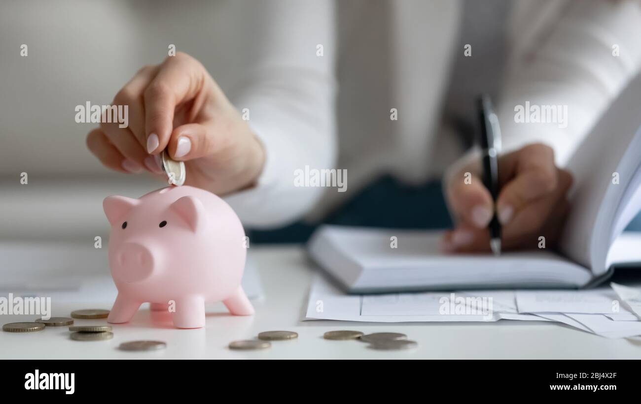 Close up of woman saving money managing home finances Stock Photo