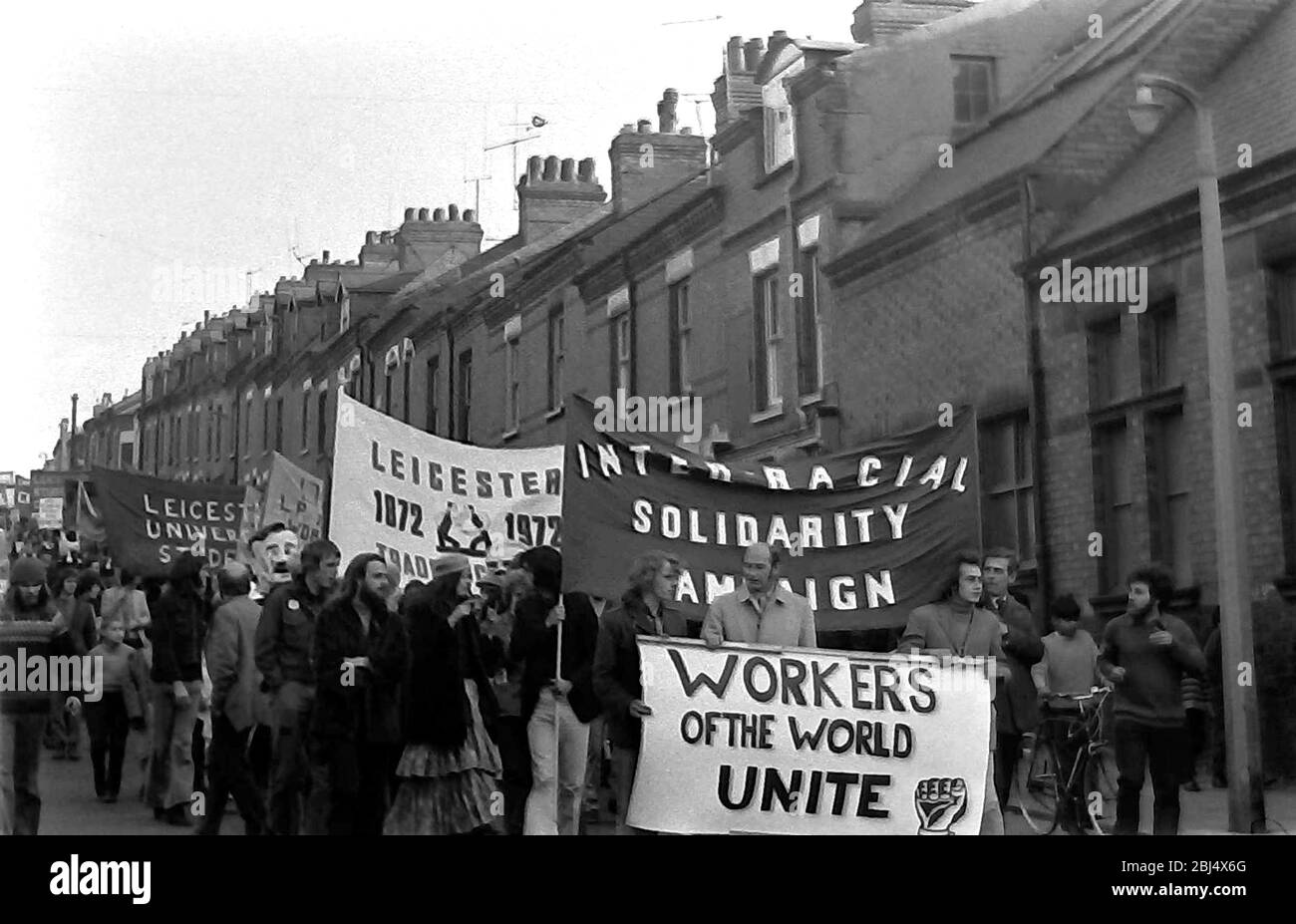 Demonstrators carrying banners, including one that says: 'Workers of the World Unite', take part in an anti racism demonstration in Leicester,  England, United Kingdom, British Isles, in 1972. Stock Photo