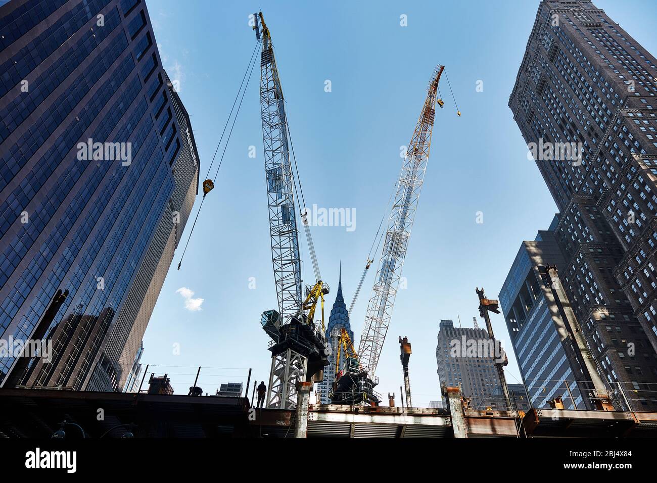 View of the Chrysler Building through construction cranes along 42nd Street in New York City. Stock Photo