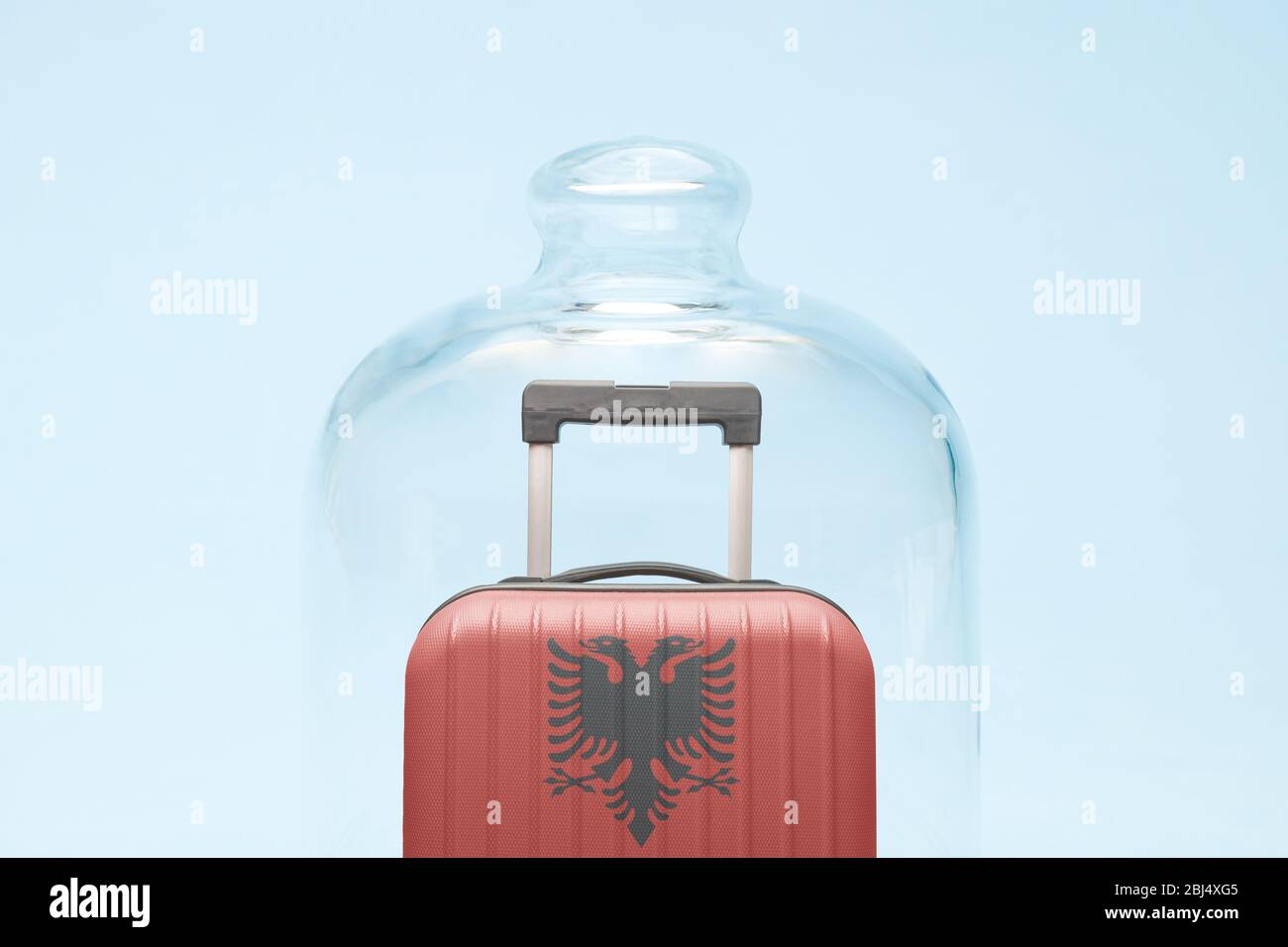 Suitcase with Albanian flag design in quarantine minimal creative coronavirus travel restriction concept. Stock Photo