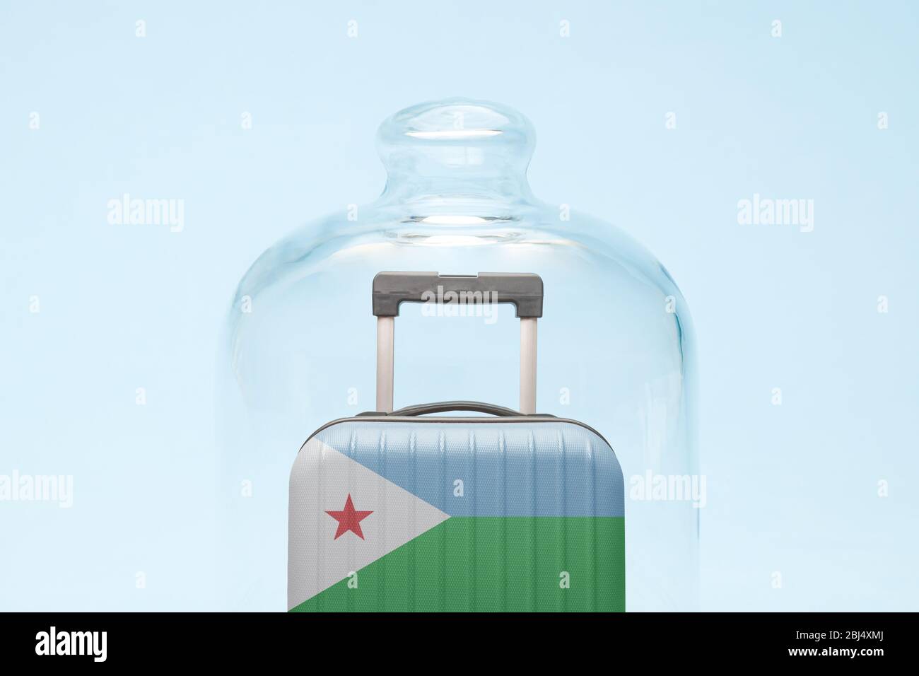 Suitcase with Djibouti flag design in quarantine minimal creative coronavirus travel restriction concept. Stock Photo