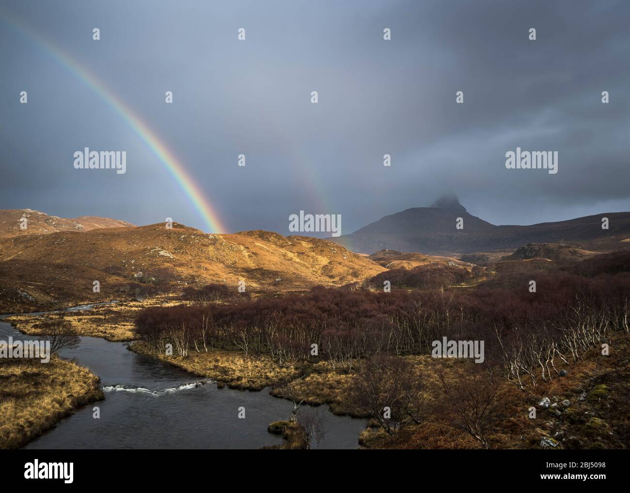 A rainbow appears over the River Polly after a storm front passes through. Stock Photo