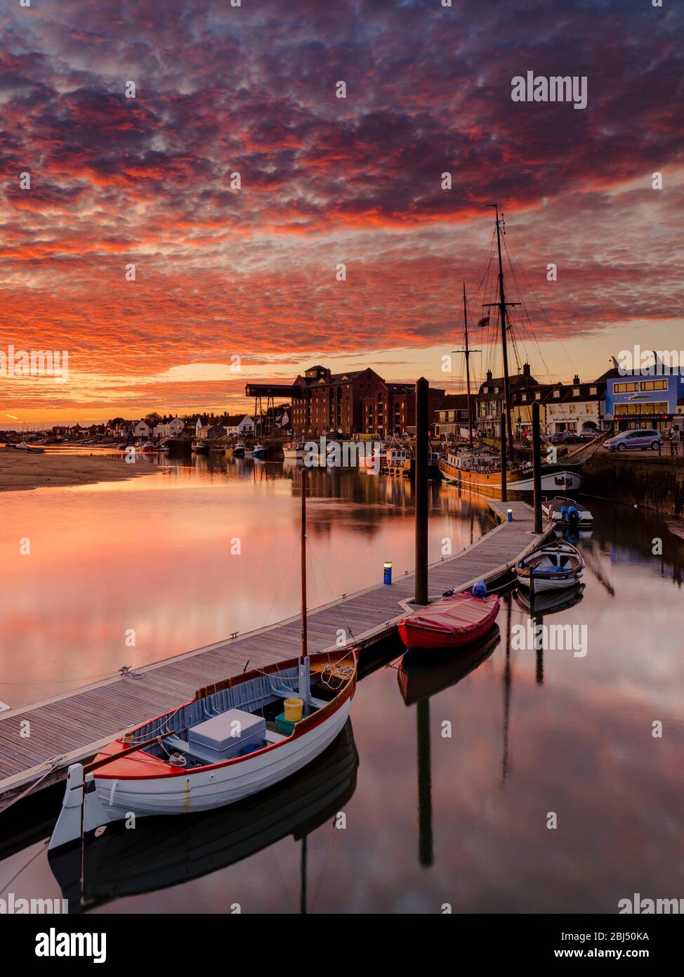 A stunning autumn sunrise over the harbour at Wells-next-the-Sea. Stock Photo