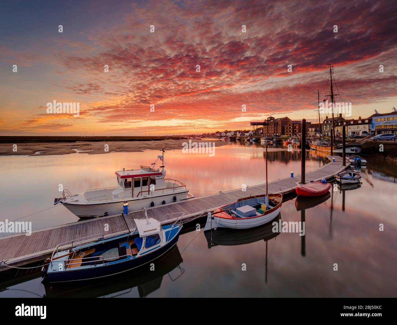 A stunning autumn sunrise over the harbour at Wells-next-the-Sea. Stock Photo