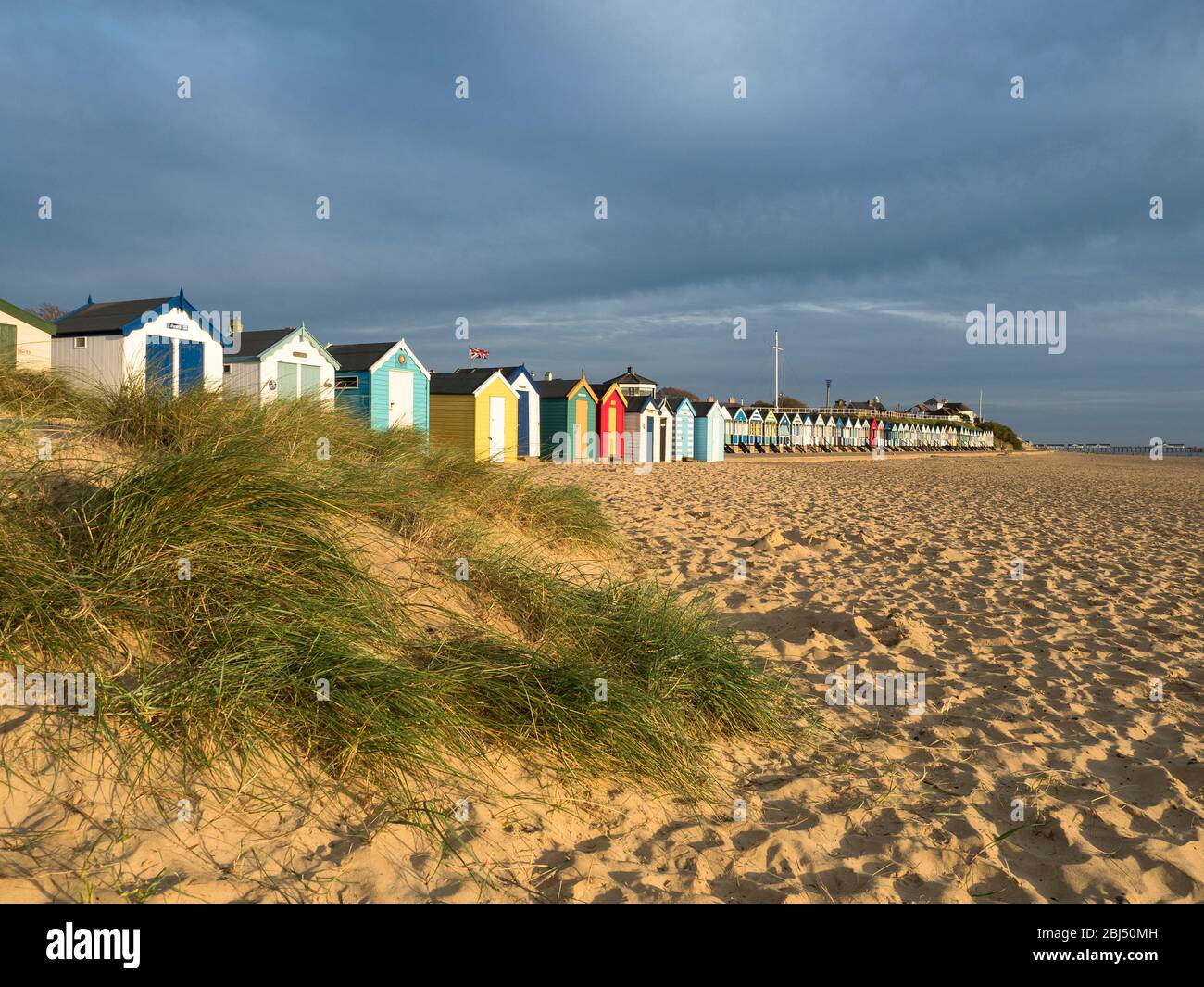 Southwold beach huts behind sand dunes. Stock Photo