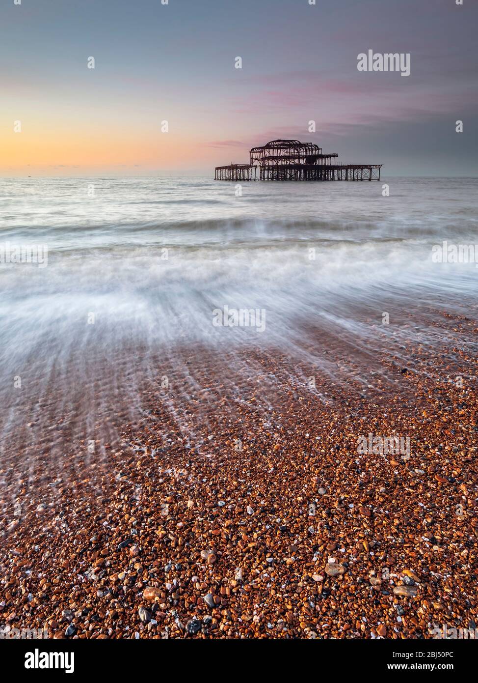 Portrait shot of the old west pier at sunrise. Stock Photo