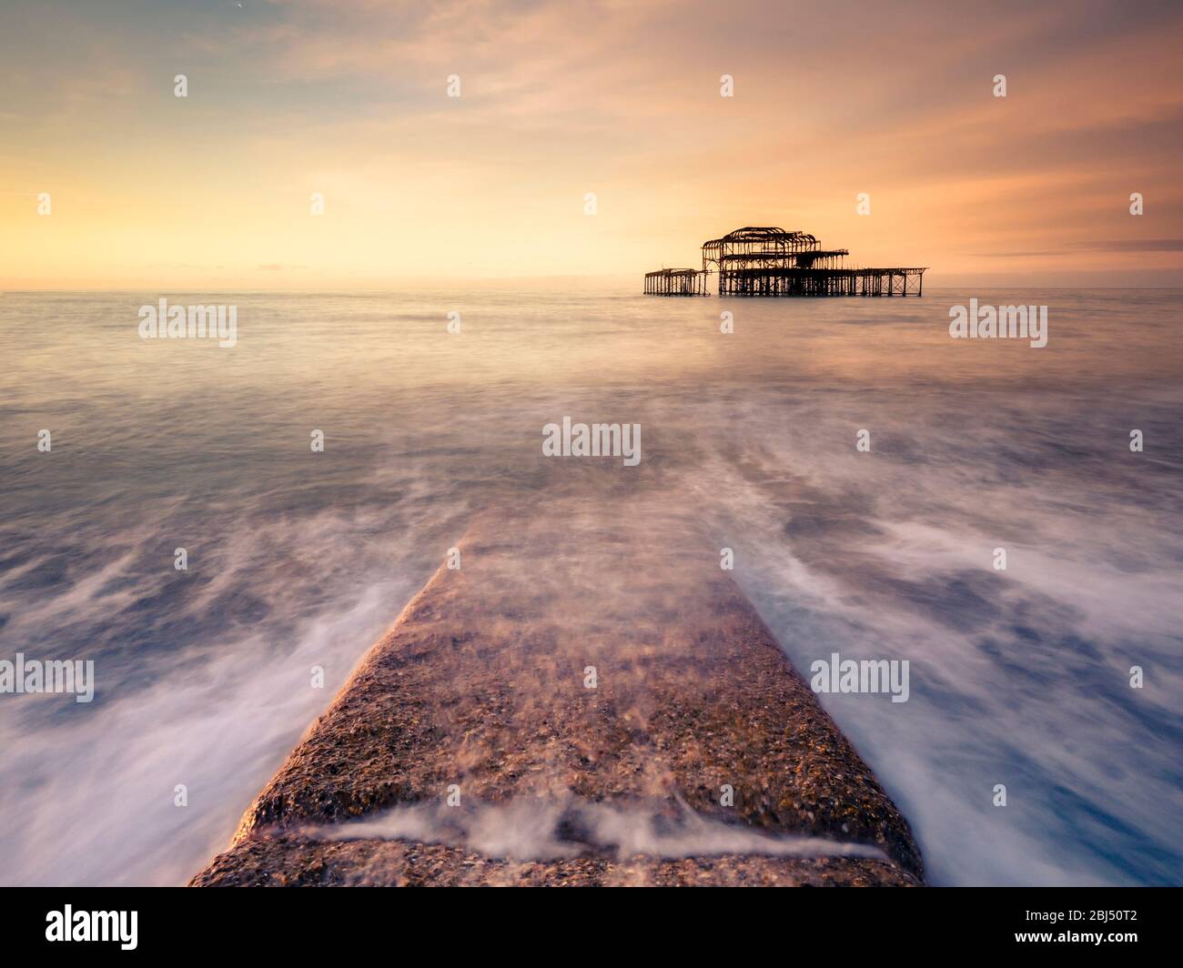 A stone path at sunrise at the old Pier in Brighton. Stock Photo