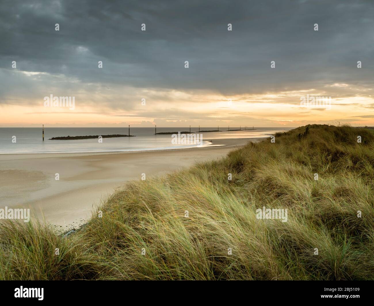 Sunrise from the dunes overlooking Sea Palling beach. Stock Photo