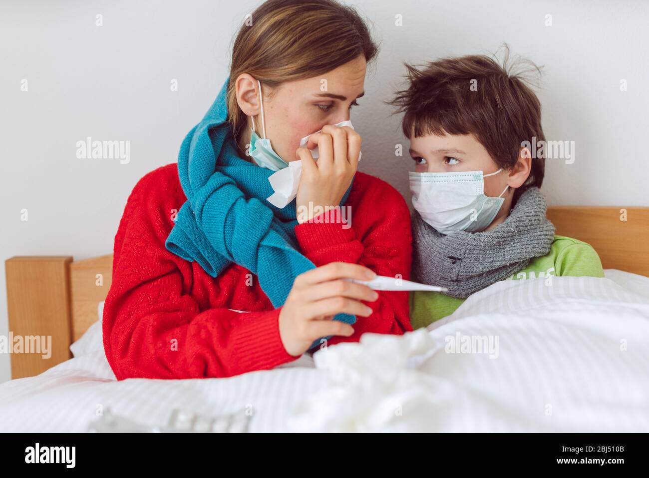 Mother and son in bed with a virus infection Stock Photo