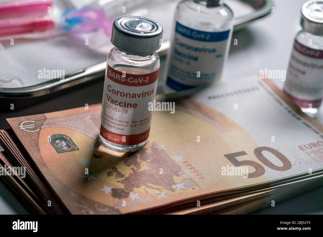 Coronavirus vial on euro banknotes, conceptual image Stock Photo