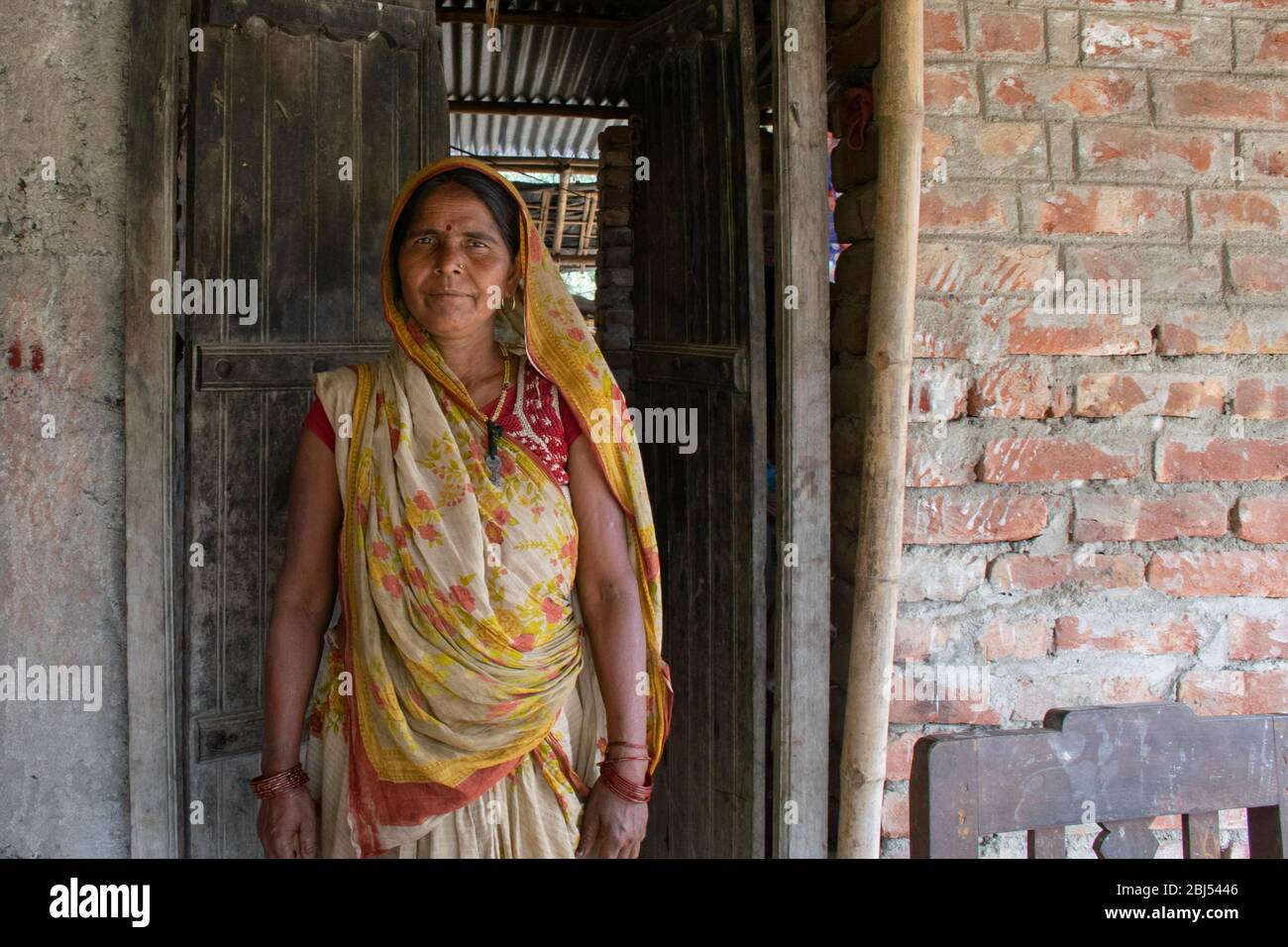 happy rural woman standing at the door Stock Photo